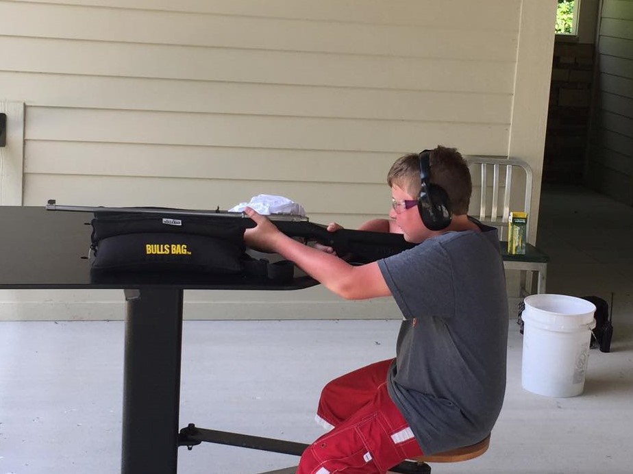 Camper practicing firearm safety at a shooting range