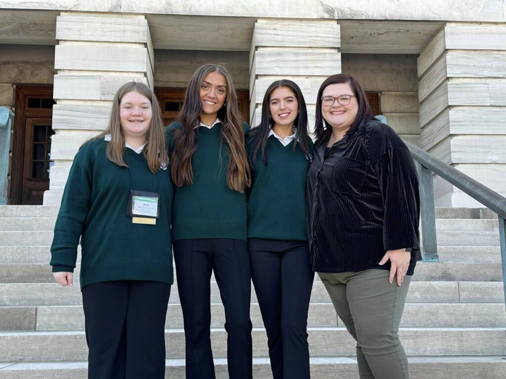 4 people standing in front of outside steps